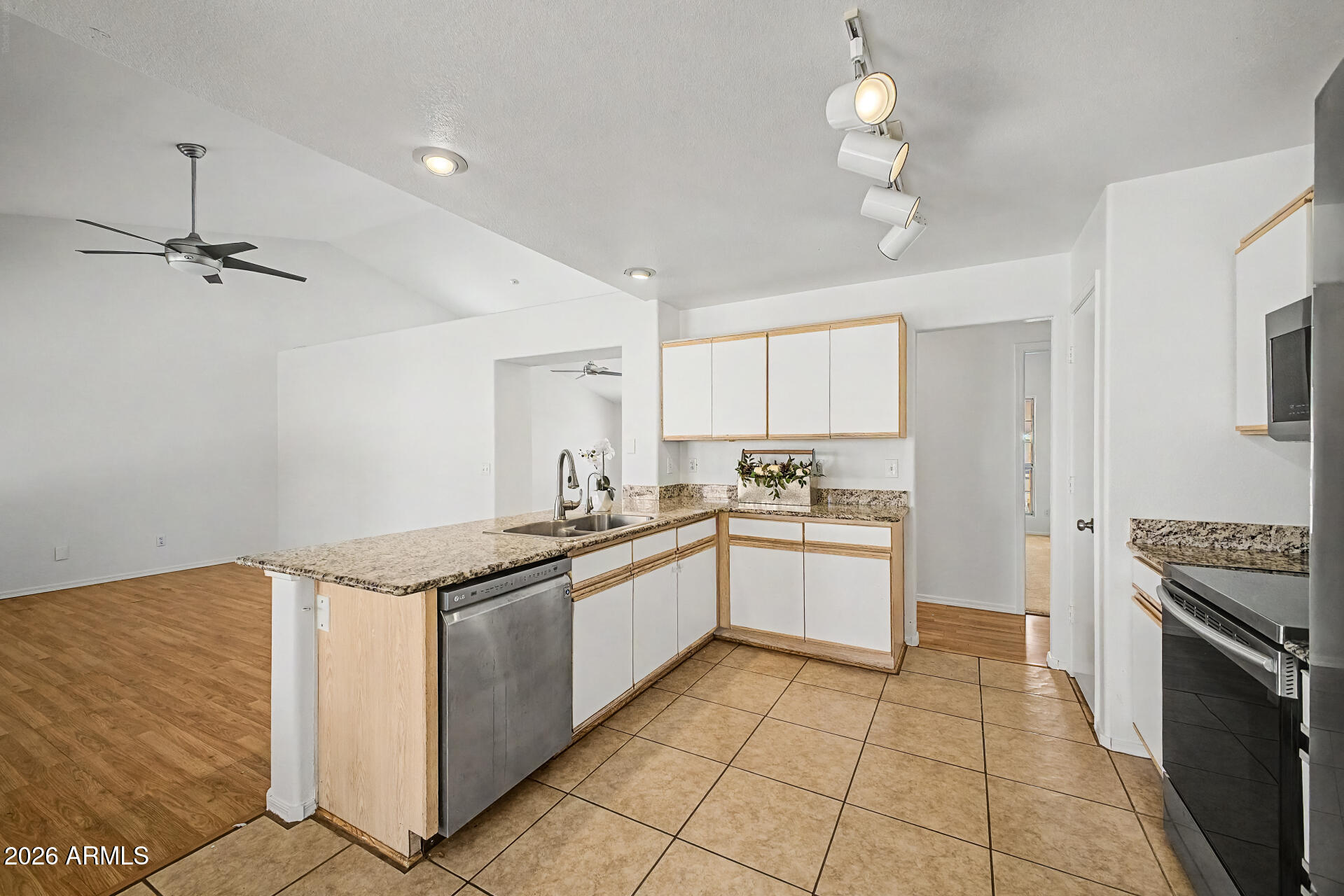 2762 North Ricardo Mesa, AZ 85215 - Photo 17 of 38 a kitchen with stainless steel appliances granite countertop a sink and cabinets
