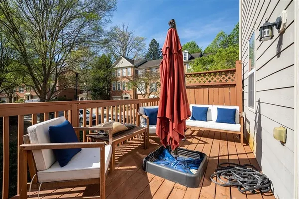 a view of balcony with wooden floor and outdoor seating