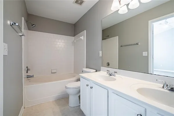 a bathroom with a double vanity sink mirror double and bathtub