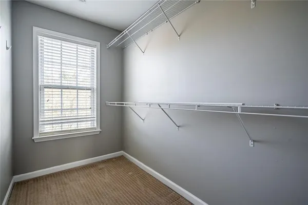 a view of a room with rack on the wall and a window