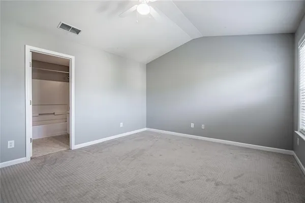 a view of an empty room and a bathroom