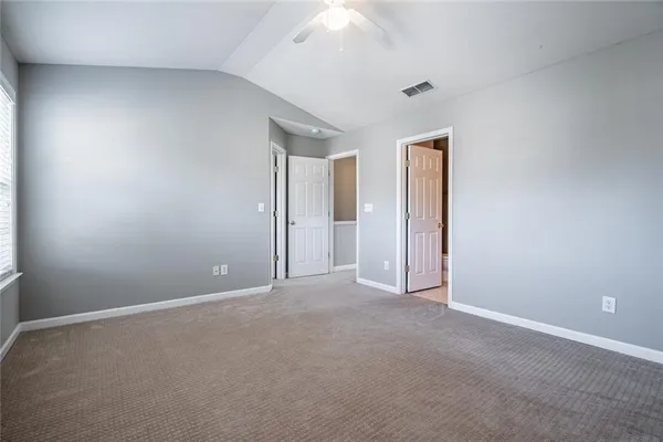 a view of an empty room and a ceiling fan