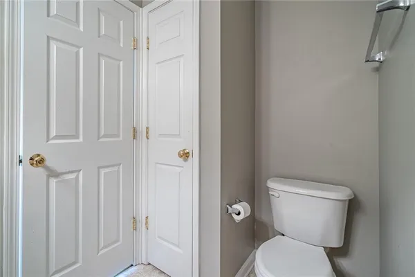 a white toilet sitting next to a shower curtain