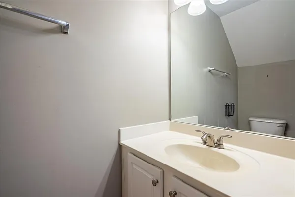 a bathroom with a sink vanity and a mirror