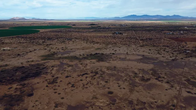 a view of dirt and mountain view in back