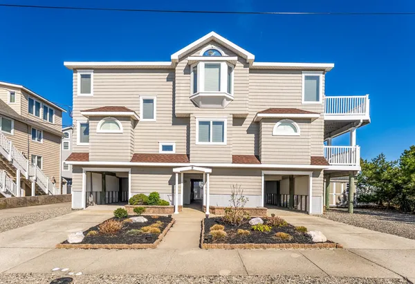 a kitchen with stainless steel appliances granite countertop a refrigerator a sink a stove and white cabinets