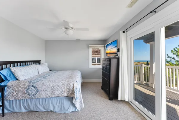 a bedroom with a large bed and a flat tv screen on a dresser