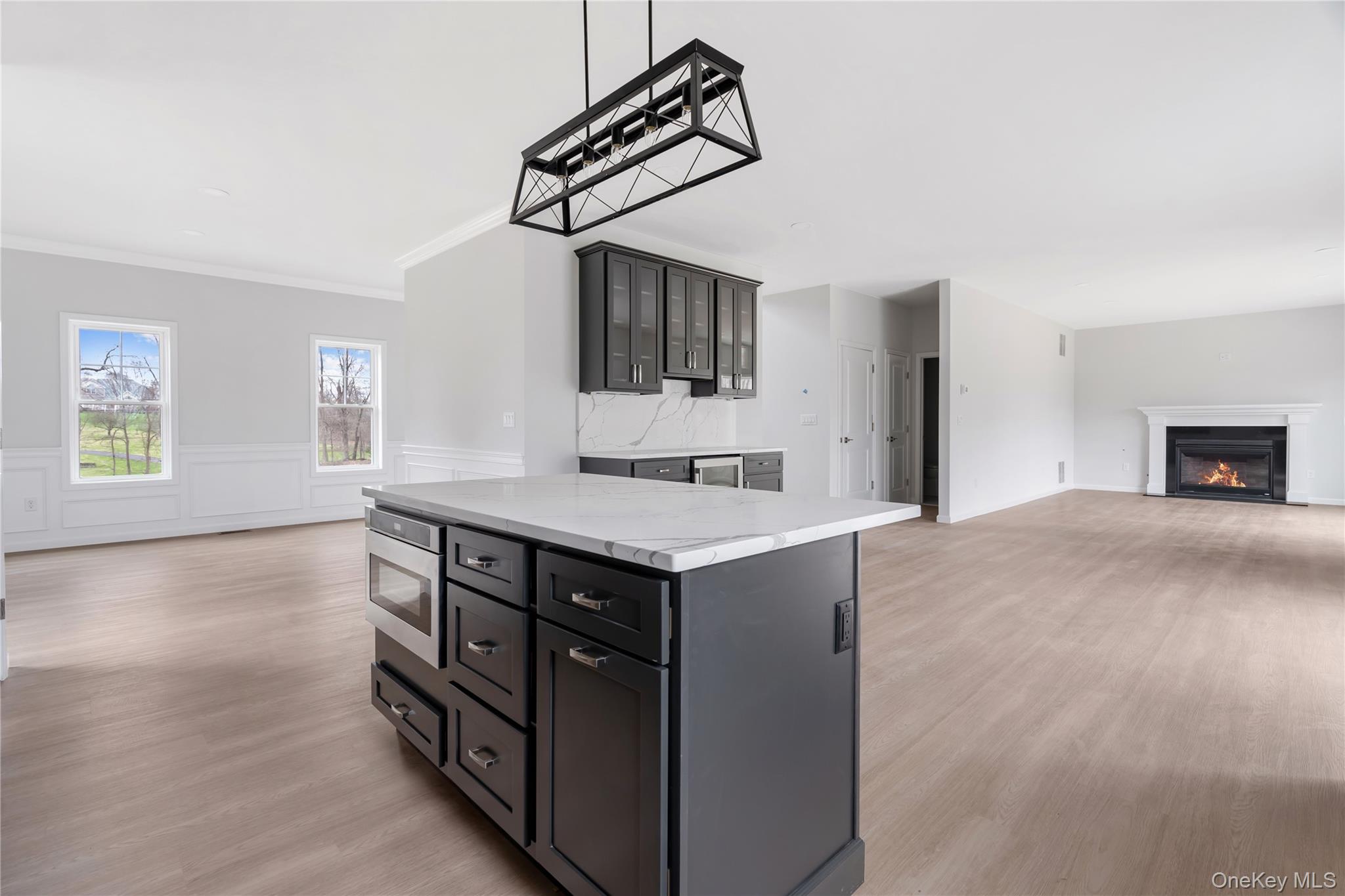 346 Old Hopewell Road Wappingers Falls, NY 12590 - Photo 40 of 42 a kitchen with kitchen island a wooden floor and a refrigerator