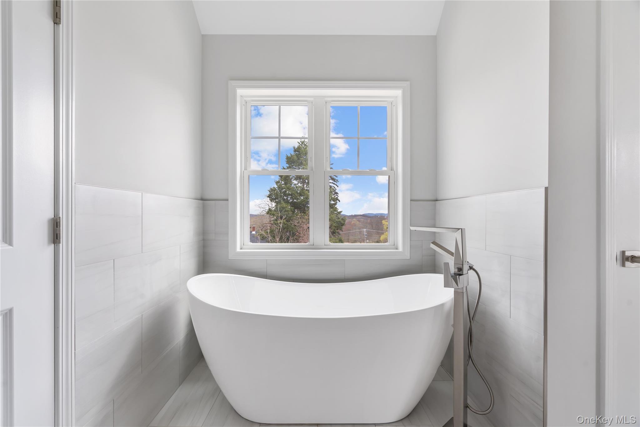 346 Old Hopewell Road Wappingers Falls, NY 12590 - Photo 23 of 42 a white bath tub sitting in a bathroom next to a window