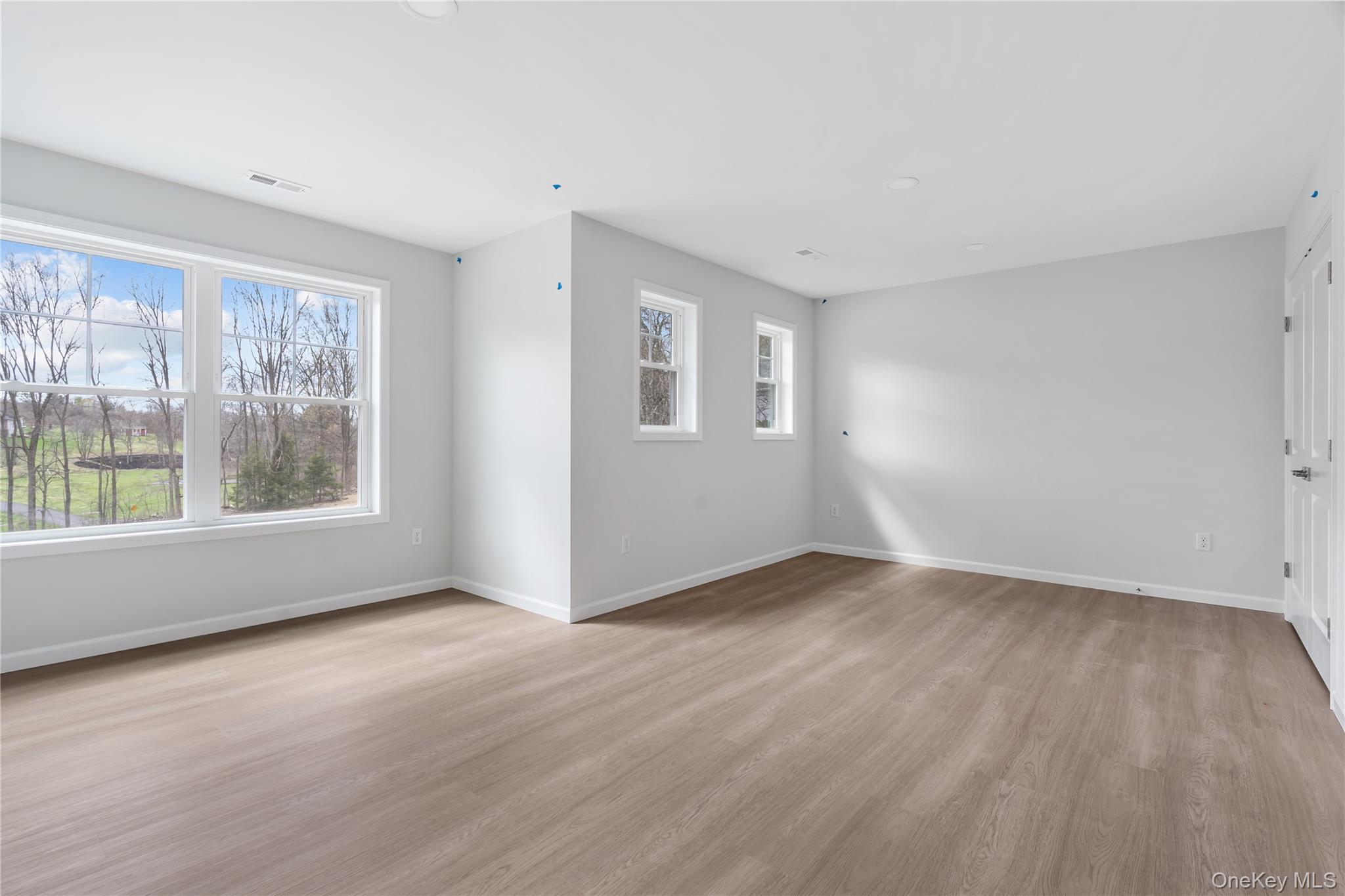 346 Old Hopewell Road Wappingers Falls, NY 12590 - Photo 30 of 42 an empty room with wooden floor and windows