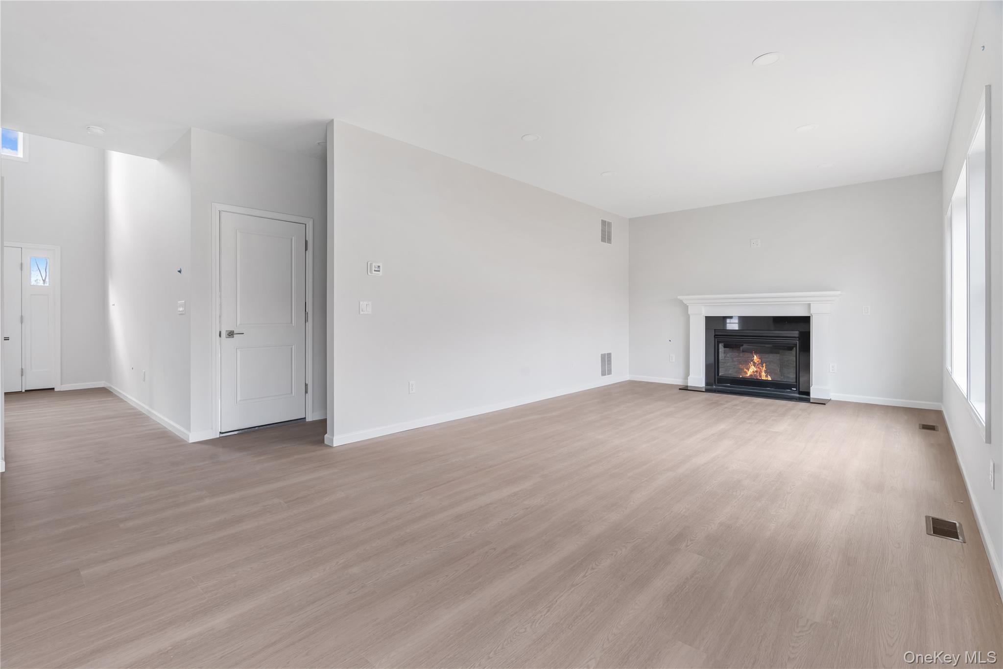 346 Old Hopewell Road Wappingers Falls, NY 12590 - Photo 5 of 42 an empty room with wooden floor and fireplace