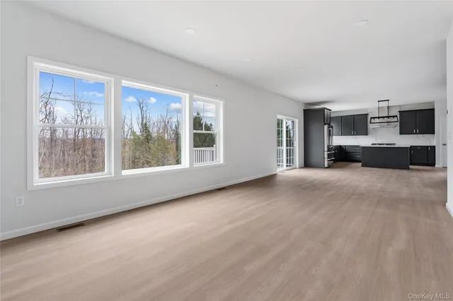 a view of a bedroom with furniture and window