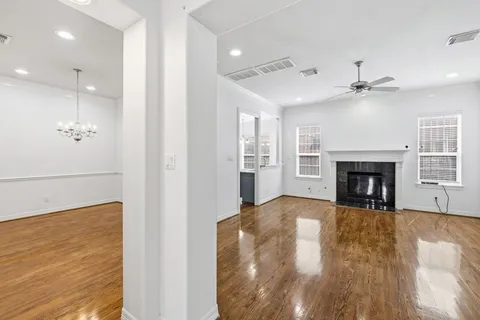an empty room with windows and a fireplace