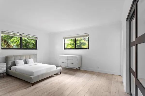 a living room with furniture and a painting on the wall