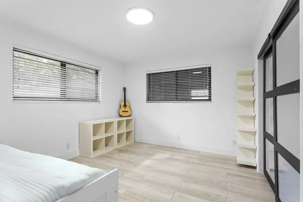 a room with a bed and a large window