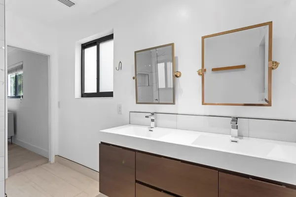 a bathroom with a sink a toilet and a mirror