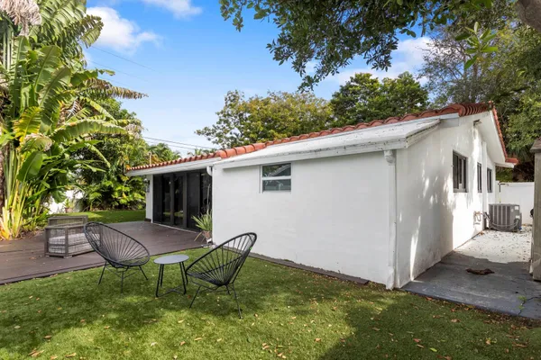 a view of backyard with seating area and green space