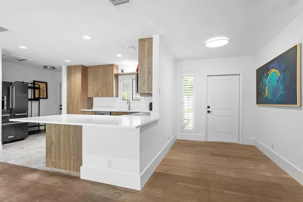a kitchen with stainless steel appliances granite countertop a sink and a refrigerator