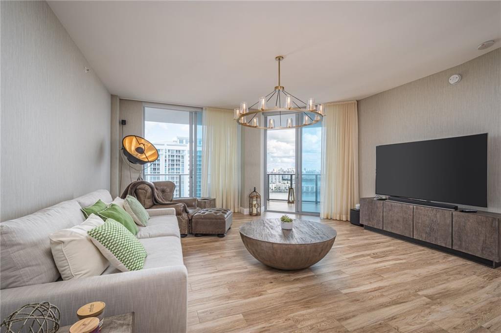 17111 Biscayne Boulevard North Miami Beach, FL 33160 - Photo 11 of 37 a living room with furniture and a flat screen tv