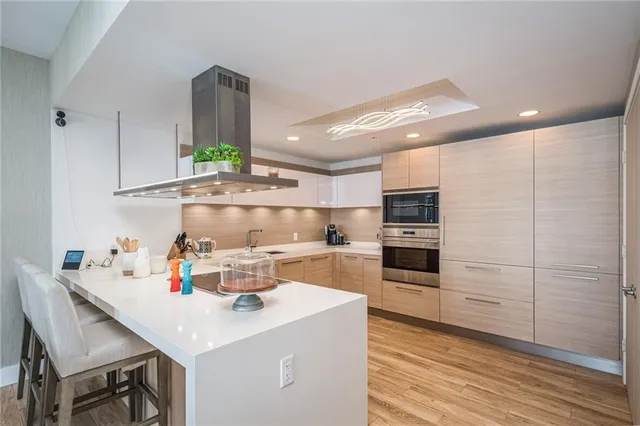 a kitchen with a table chairs and white cabinets