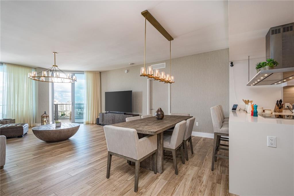 17111 Biscayne Boulevard North Miami Beach, FL 33160 - Photo 22 of 37 a view of a dining room with furniture window and wooden floor