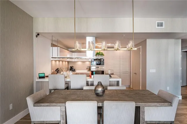 a bedroom with a bed and a flat screen tv on dresser