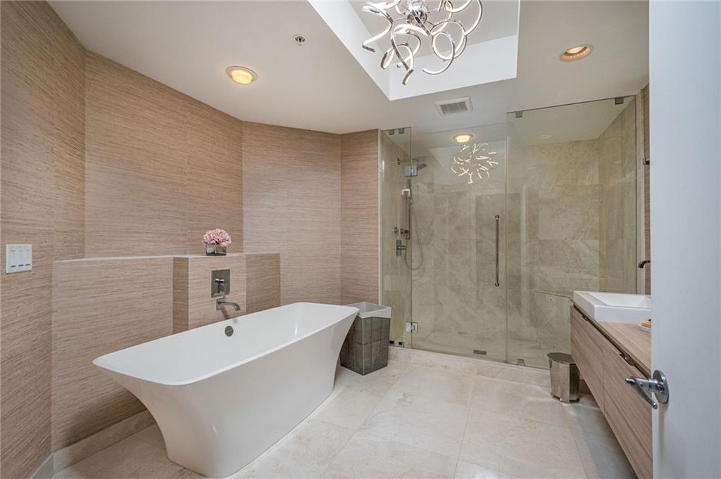 17111 Biscayne Boulevard North Miami Beach, FL 33160 - Photo 29 of 37 a bathroom with a tub a sink and mirror