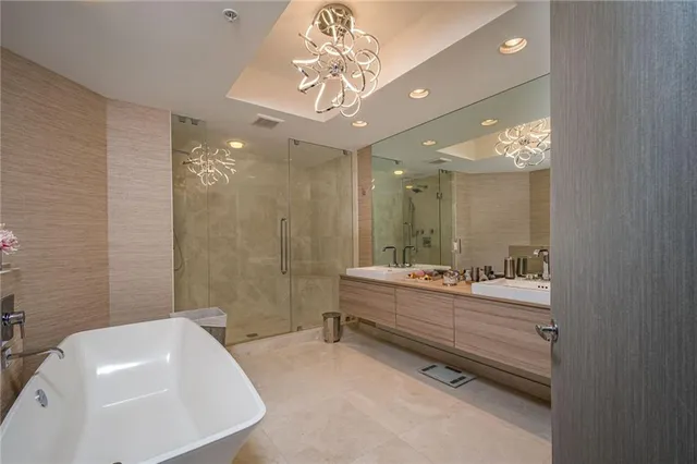 a bathroom with a sink a tub and a mirror