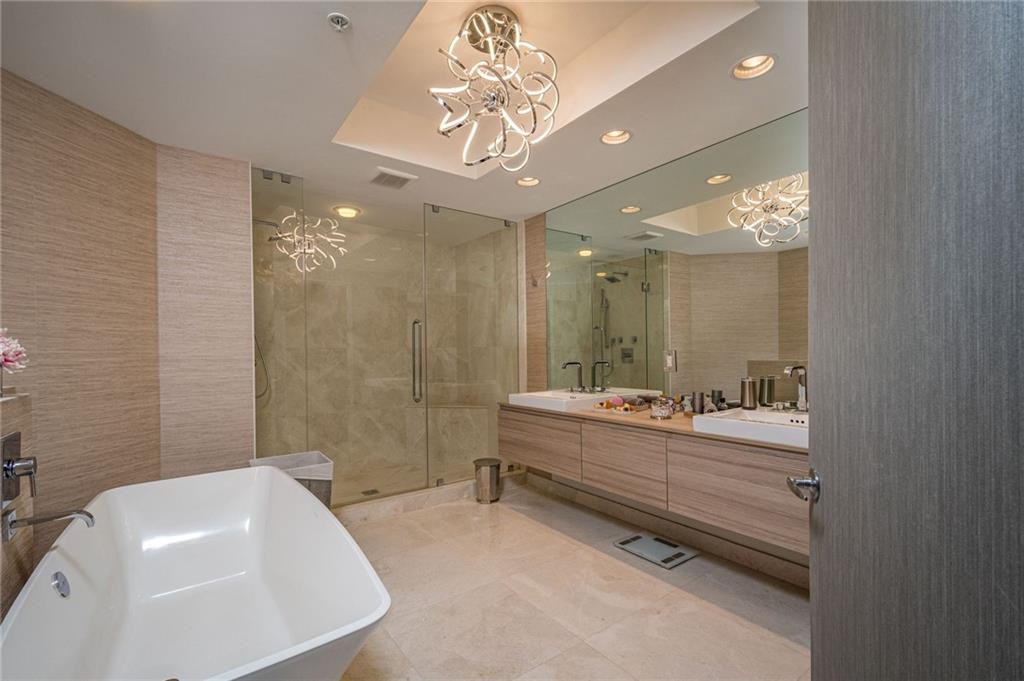 17111 Biscayne Boulevard North Miami Beach, FL 33160 - Photo 31 of 37 a bathroom with a double vanity sink mirror and bathtub