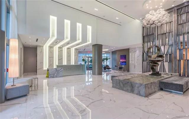 a living room with fireplace furniture and a chandelier