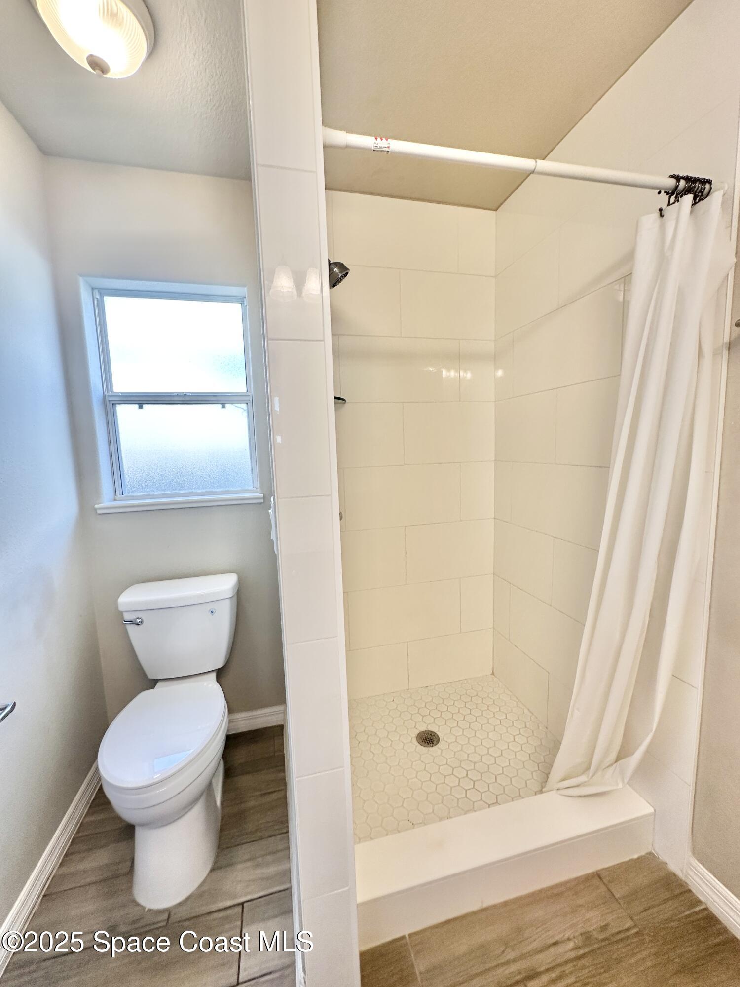 449 Alison Street Titusville, FL 32780 - Photo 13 of 22 a bathroom with a toilet and a shower