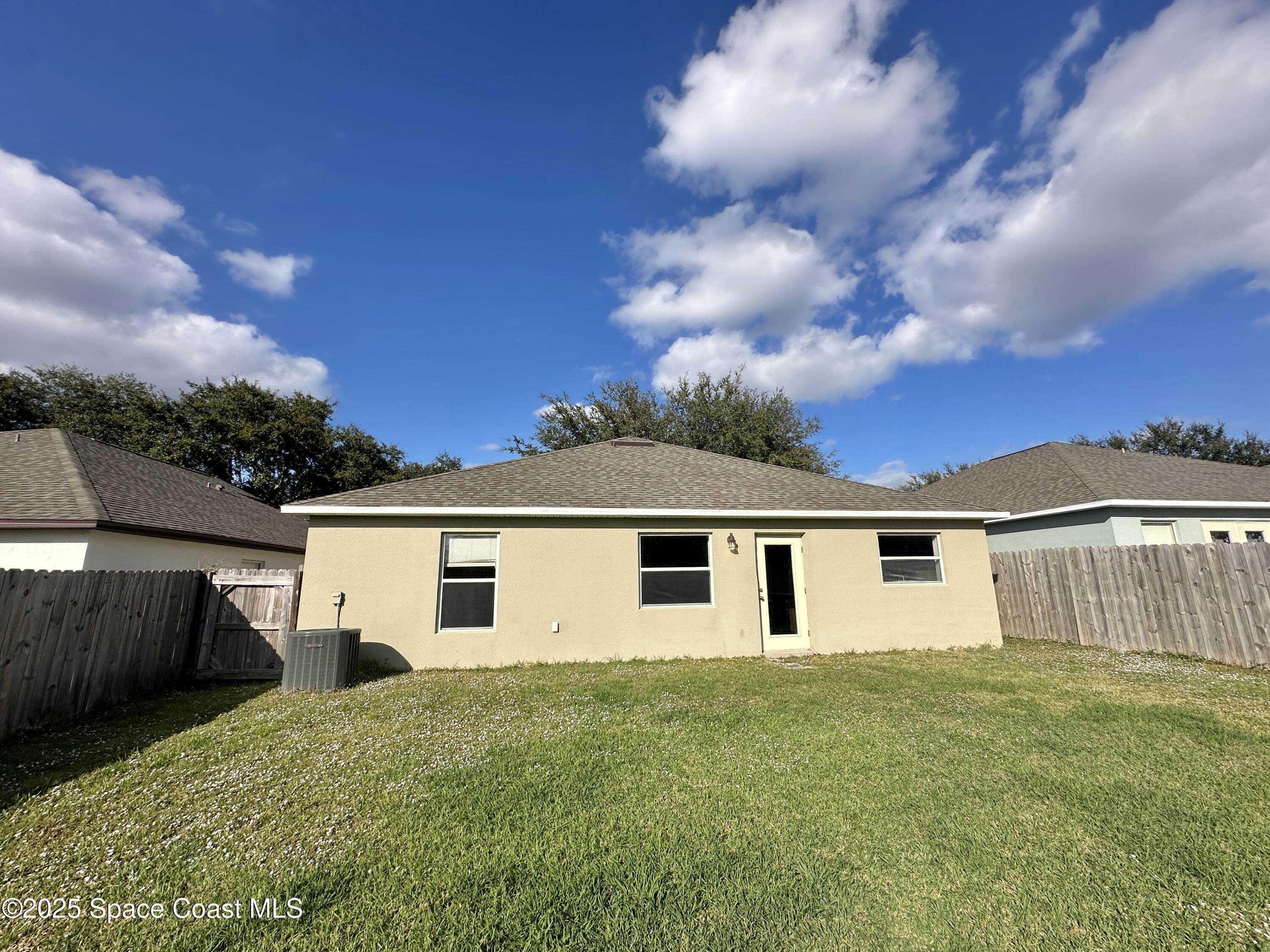 449 Alison Street Titusville, FL 32780 - Photo 20 of 22 a view of a house with a backyard