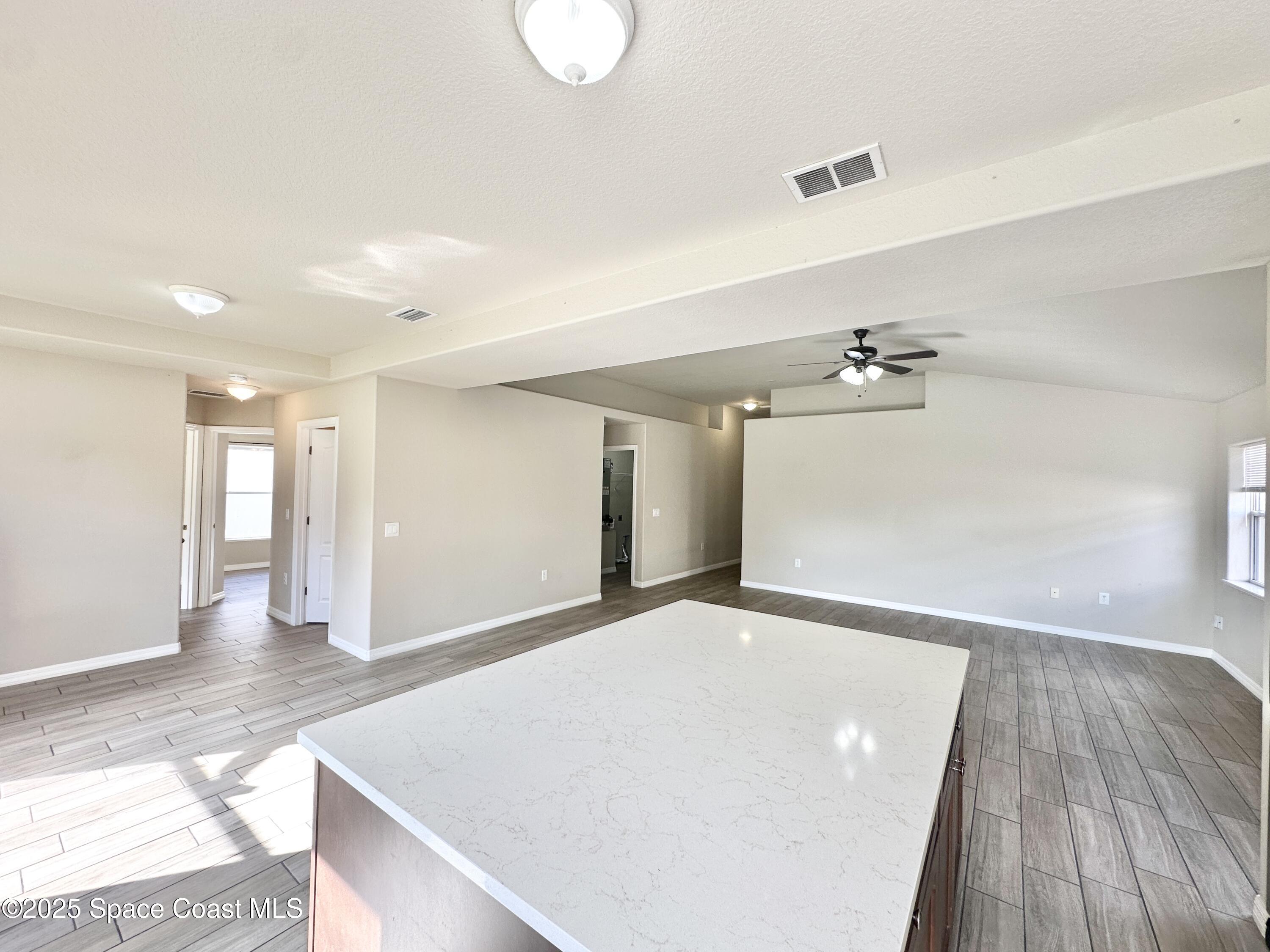 449 Alison Street Titusville, FL 32780 - Photo 9 of 22 a view of a room with a window and wooden floor