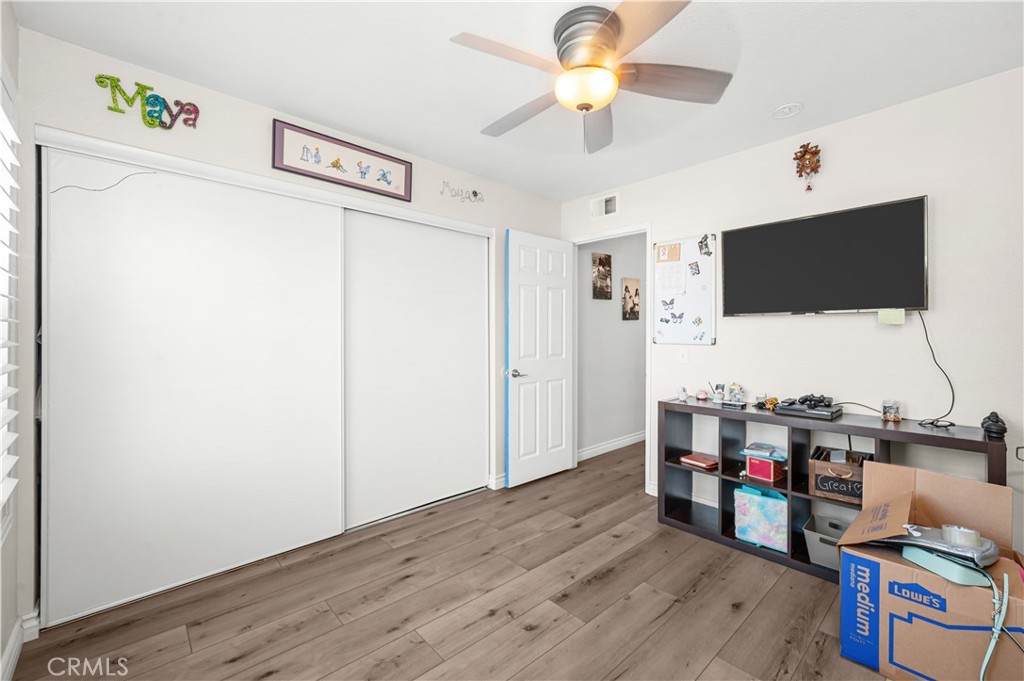 19465 Kinnow Lane Riverside, CA 92508 - Photo 34 of 61 a view of a livingroom with workspace and a flat screen tv