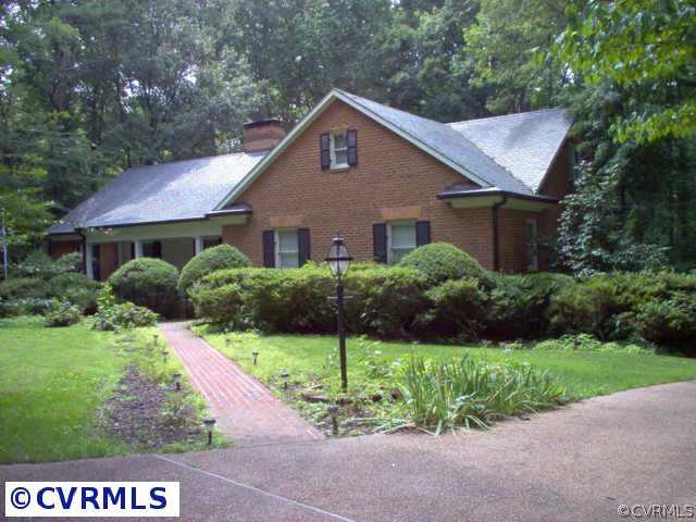 9201 Cardiff Road Richmond, VA 23236 - Photo 2 of 8 a front view of a house with a yard and garage