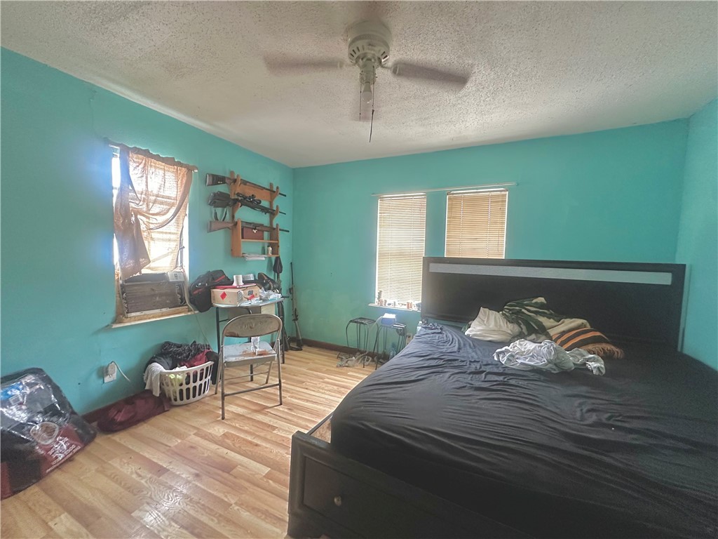 801 Ruben Chavez Road Robstown, TX 78380 - Photo 10 of 18 a bedroom with furniture and a wooden floor