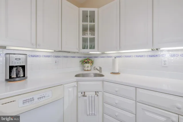 a kitchen with a white cabinets and a window