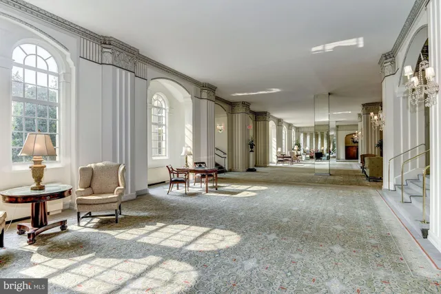 a living room with furniture and large windows