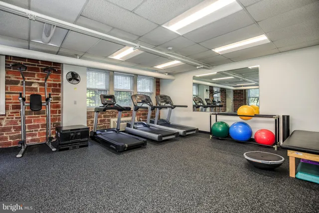 a room with furniture and gym equipment