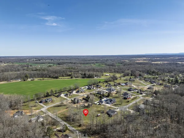 an aerial view of a residential houses with outdoor space
