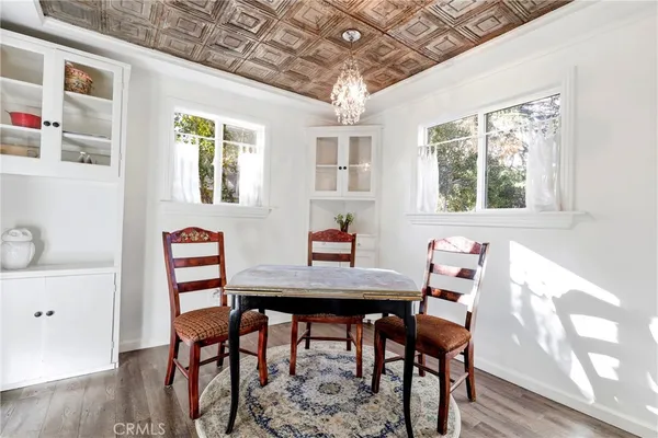 a kitchen with white cabinets and sink