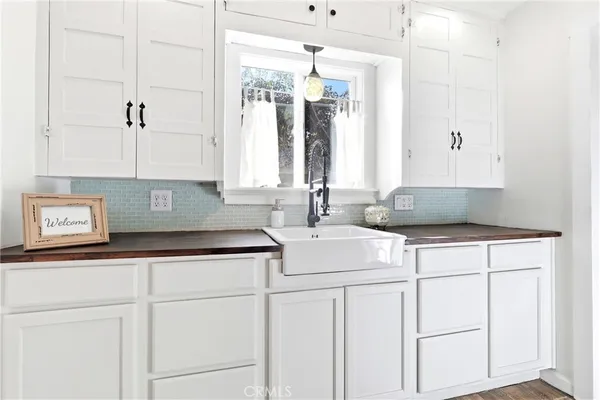 a kitchen with stainless steel appliances white cabinets and a refrigerator