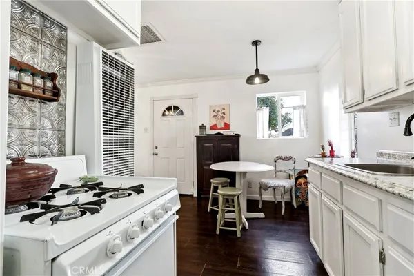 a kitchen with stainless steel appliances granite countertop a sink and a refrigerator