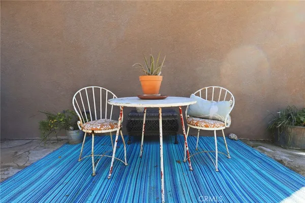 a view of a chairs and table in the backyard