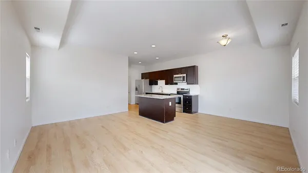a kitchen with a sink window and stainless steel appliances