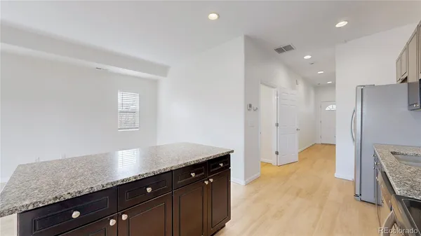 a spacious bathroom with a granite countertop sink