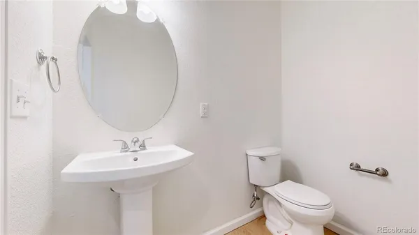 a bathroom with a sink toilet and a mirror