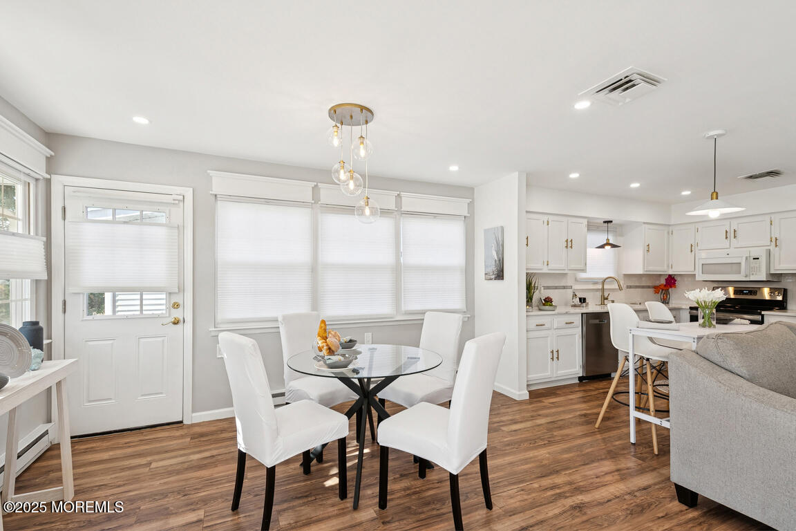 5 Phillips Road Brick, NJ 08724 - Photo 6 of 31 a view of a dining room with furniture a kitchen and chandelier