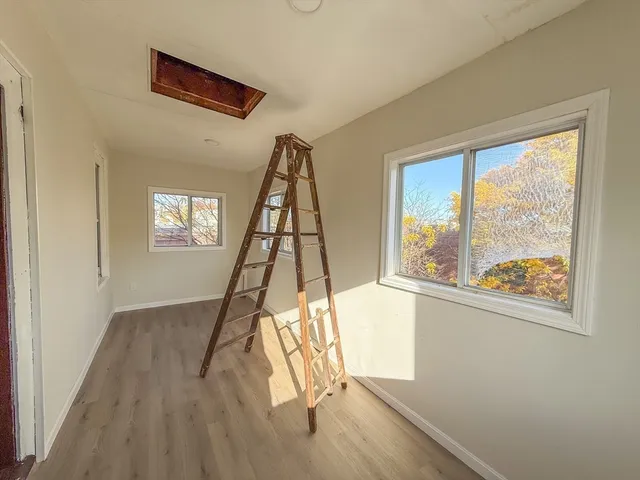 a view of a livingroom with wooden floor and windows