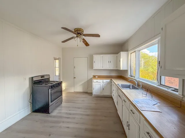 a kitchen with granite countertop a stove and a sink
